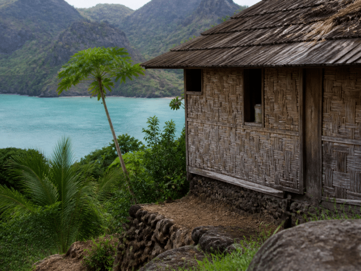 Maison polynésienne traditionnelle surplombant lagon turquoise Nuku-Hiva