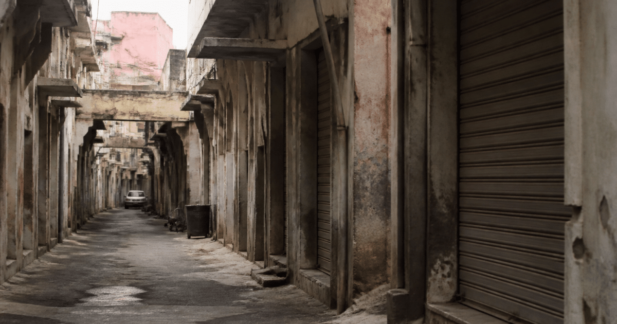 Rues etroites degradees avec immeubles decrepits et graffitis visibles